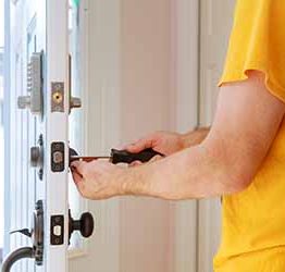 Worker installing or repairing new lock handyman repair the door lock